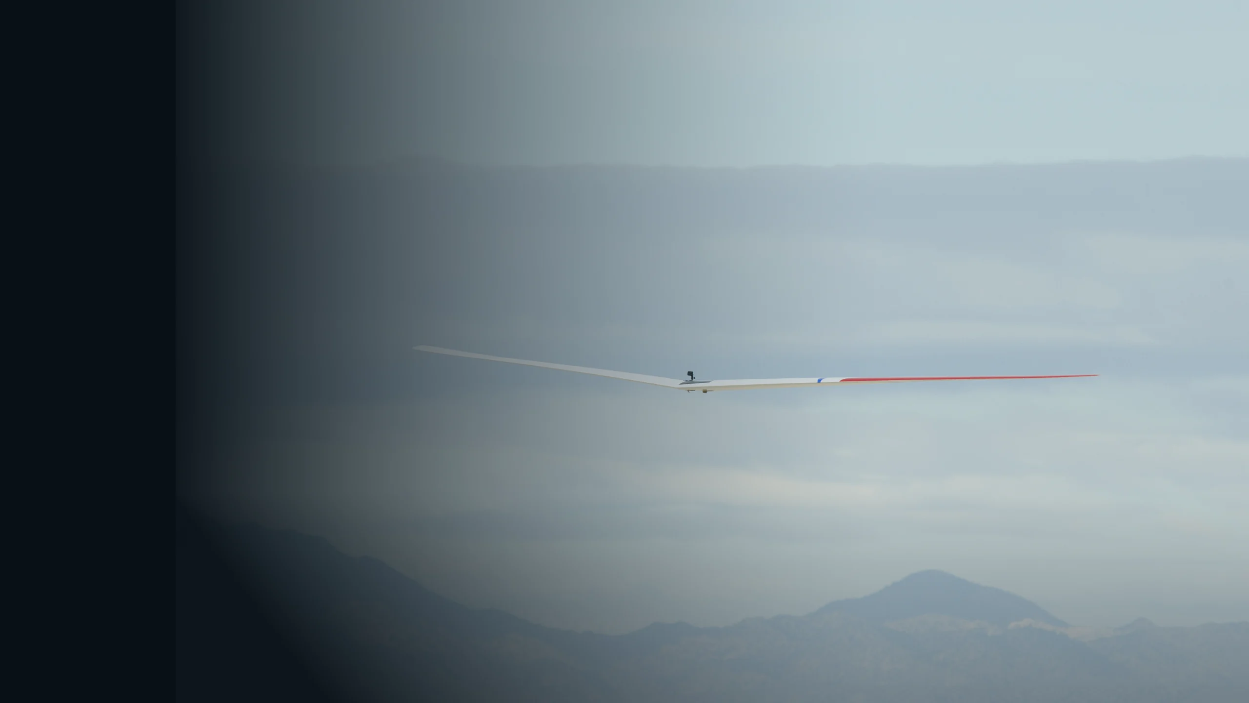 NASA Prandtl-D research glider flying above desert mountains